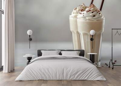 Two smooth milkshakes on a white tabletop. Wall mural