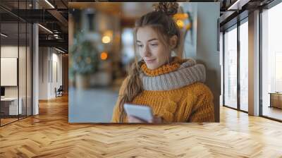 Girl looking at smart thermostat at home, checking heating temperature. Concept of sustainable, efficient, and smart technology in home heating and thermostats Wall mural