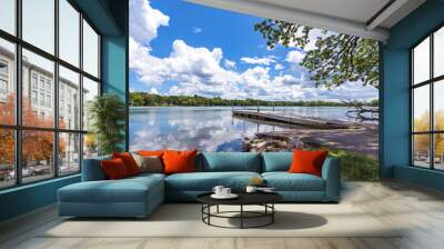 Looking at the boat launch on Genesee Lake in Waukesha County, Wisconsin.  Lazy cumulus clouds are reflected in the calm lake waters. Wall mural