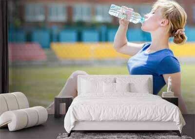 Fitness woman exercising outdoors Wall mural