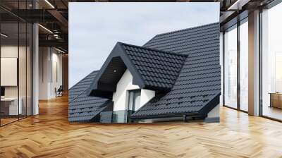 A beautiful modern house is covered with black metal tiles. Roofing of metal profile wavy shape Wall mural