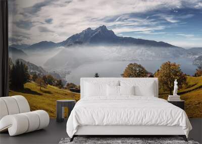 Idyllic mountain landscape in the Swiss Alps with blooming meadows, rocky mountains and calm lake in sunny day. Wonderful springtime landscape in mountains. Amazing nature scenery of Switzerland Wall mural