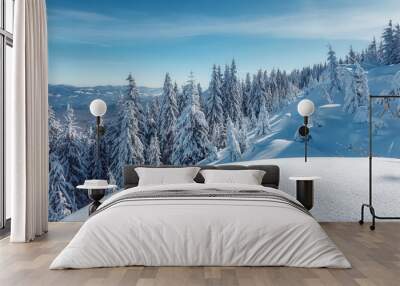 Winter background of snow and frost Fantastic winter forest landscape during sunset. Icy snowy fir trees glowin in sunlight. winter holiday concept. wonderland in winter. Christmas Holiday Concept. Wall mural