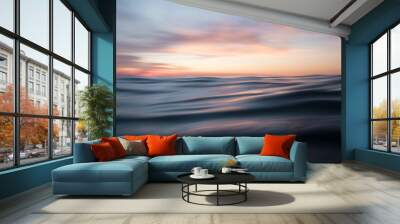 Low angle view of sunset over ocean waves Wall mural