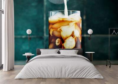 Cold-brew iced coffee with cream swirl pour Wall mural