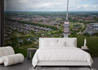 A Gerbrandy Tower next to a city and greenfield Wall mural