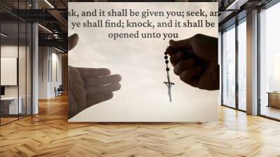 Christian prayer with hand holding Holy Rosary - Ask, and it shall be given you; seek, and ye shall find; knock, and it shall be opened unto you. Religion concept Wall mural