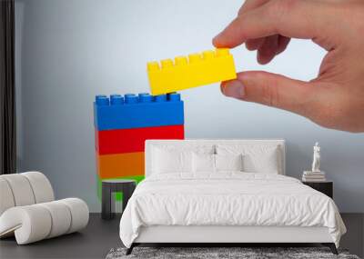 Plastic building-block toys on white cover background. Childhood toy concept Wall mural