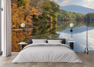 Tranquil autumn scene near Harrisville, New Hampshire. Colorful display of fall foliage along Childs Bog Pond with mirror image reflection of sky and Mount Monadnock on calm water. Wall mural