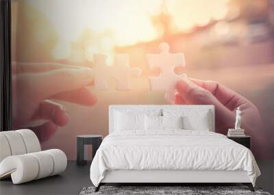 Close Up hand of man and woman connecting jigsaw puzzle with sunlight affect, Business solutions partnership success and strategy concept Wall mural