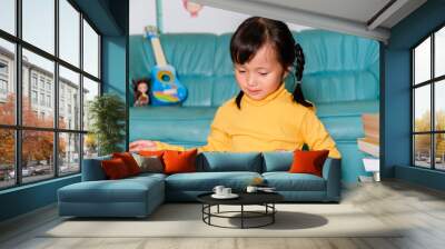 School Home work concept,Asian children wearing yellow casual clothing doing school home work drawing in Living room during the COVID-19 quarantine. Coronavirus isolation. online studying from home Wall mural