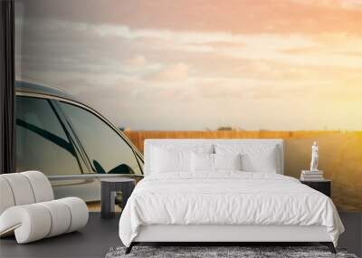 The car stretches out the sunset horizon Wall mural