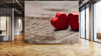 2 beautiful red hearts on a rustic wooden table on valentine's day Wall mural