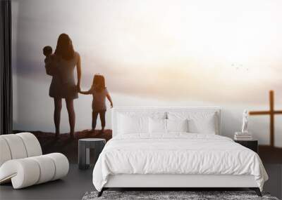 a beautiful family in a sunset on a background with the cross of christ - god hopelessness help concept Wall mural