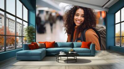 At the airport, a young woman wears a beaming smile as she gets ready to board her flight with enthusiasm. Wall mural