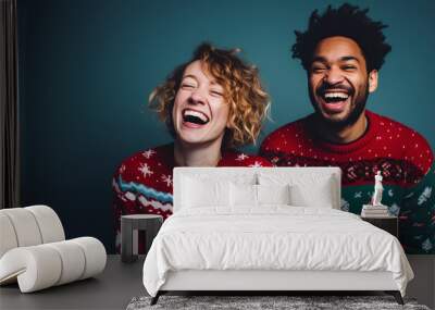 beautiful happy couple with Christmas sweaters and a blue background celebrating the Christmas and New Year holidays Wall mural