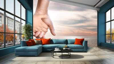 father and son hand on a sunset background Wall mural