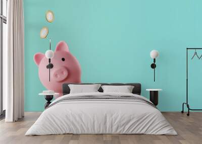 pink piggy bank with coins falling inside - savings concept Wall mural