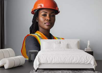 portrait of a female construction worker looking at the camera with her arms crossed on a white background Wall mural