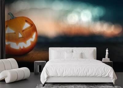 Pumpkin Jack O 'Lantern with spooky glowing eyes on Halloween night Wall mural