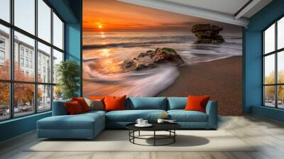 Sea sunrise. Stormy sea beach with slow shutter and waves flowing out
 Wall mural