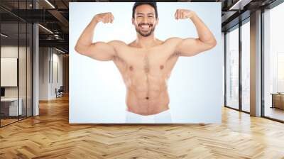 Fitness, biceps and portrait of a man flexing in a studio after an arm muscle training workout. Sports, health and strong Asian male bodybuilder after a strength exercise isolated by white background Wall mural