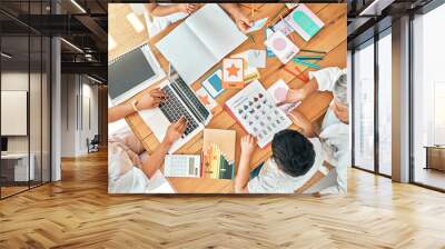 Education, learning and family together with homework, academic material and children study, people and table top view. Grandparents helping kids, learn while mother working on laptop and development Wall mural