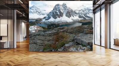 Looking from behind a boulder at the snow covered peaks of Assiniboine and Sunburst Wall mural