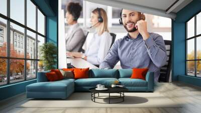 Portrait, call center and customer service with a man consulting using a headset in his support office. CRM, contact us or telemarketing with a male consultant working in an agency for communication Wall mural