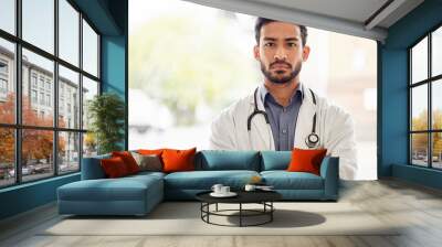 Arms crossed, serious and man doctor portrait in hospital with stethoscope, attitude and determined mindset. Proud, face and Japanese health expert worker in a clinic for help, advice and service Wall mural