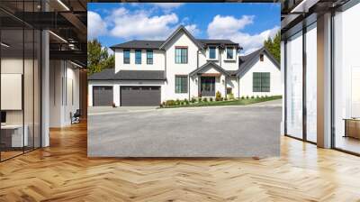 Front view of a big white beautiful house in the suburbs,  luxury two garage home with luscious green grass  on a blue sky day. Wall mural