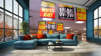 store closing and huge discount signs displayed at a going out of business sale iii Wall mural