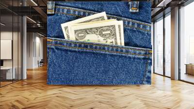 Several one dollar bills in the back pocket of jeans. Concept of absentminded person, potential victim of theft. Wall mural