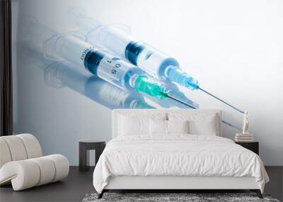 Two syringes with medicinal solution, on light blue background with reflection. 2 ml syringe macro close up Wall mural