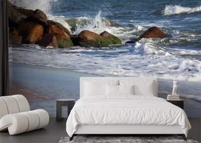 Waves crashing the rocks on the beach Wall mural