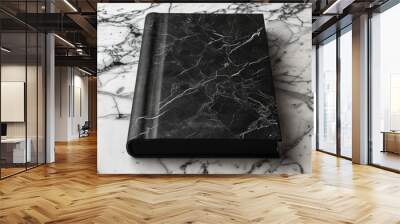  A black-and-white book sits atop a white marble counter, nearby two identical black-and-white marble counters Wall mural