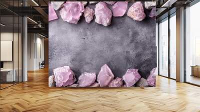   A group of pink rocks aligned on a gray background, with a space for an inscription in their midst Wall mural