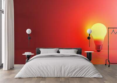   A light bulb atop a table, near a red wall The bulb emits a red glow Wall mural