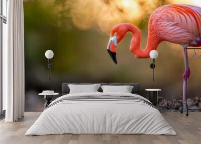  A pink flamingo atop a mound of dirt borders a verdant forest teeming with trees Wall mural