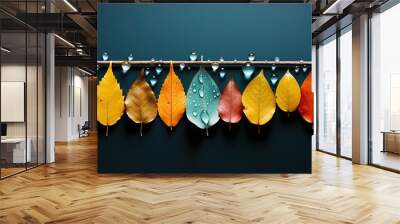  a row of colorful leaves hanging from a wooden pole with water droplets on them.  generative ai Wall mural