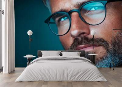  A tight shot of a bearded man in glasses emitting blue light from his eyeglasses Wall mural