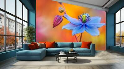  A tight shot of a solitary blue blossom against a softly blurred backdrop of red, yellow, and blue flowers Wall mural