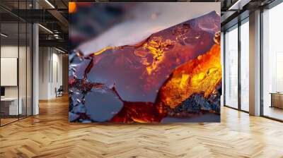  A tight shot of an ice chunk displaying orange and yellow ice crystals on its frosty surface Wall mural