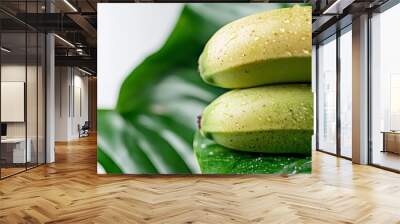  Two green bananas atop a verdant, leafy plant - raindrops drip from above Wall mural