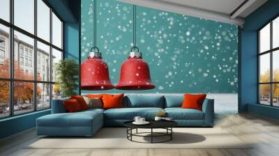 Two red bells hang against a teal background, surrounded by falling snowflakes, creating a festive winter scene. Wall mural