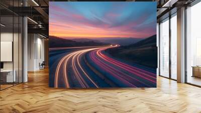 A long exposure photo of a highway at sunset, with light trails from cars creating streaks across the horizon. The road leads into the distance, with hills in the background, evoking a sense of speed. Wall mural