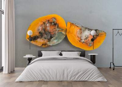 from above two very rotten pumpkin halves, mushroom food, junk food concept, gray background Wall mural