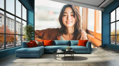 Young Asian Woman playing guitar by the window Wall mural