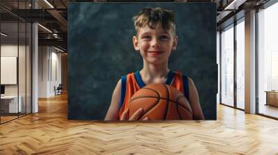 closeup portrait on dark background of beautiful active basketball player child in jersey uniform holding a basketball Wall mural