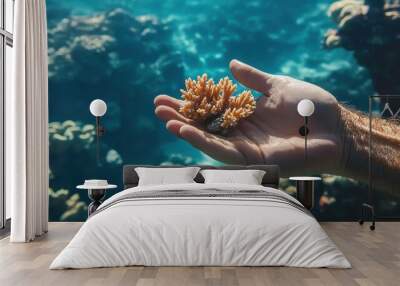 Exploring the Underwater Wonders: A Hand Holding a Vibrant Coral Reef Wall mural